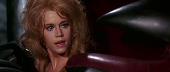 Movie still from “Barbarella” (1968), directed by Roger Vadim – A person with long blonde hair; Close Up shot, Over the shoulder angle