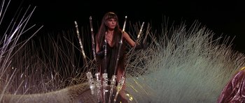 Movie still from “Barbarella” (1968), directed by Roger Vadim – A woman standing in front of a bunch of glass tubes; Medium shot, Low angle