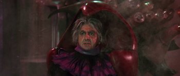 Movie still from “Barbarella” (1968), directed by Roger Vadim – A person wearing a clown costume; Medium shot, High angle