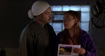 Movie still from “Barbershop” (2002), directed by Tim Story – A man and a woman looking at each other in front of a window; Close Up shot, Over the shoulder angle