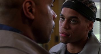 Movie still from “Barbershop” (2002), directed by Tim Story – Two men looking into each other's eyes in a room; Close Up shot, Over the shoulder angle
