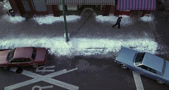 Movie still from “Barbershop” (2002), directed by Tim Story – An aerial view of a city street covered in snow; Extreme Wide shot, Overhead angle