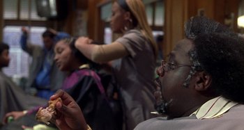 Movie still from “Barbershop” (2002), directed by Tim Story – A group of people sitting in a room; Close Up shot, Over the shoulder angle