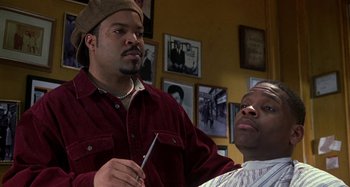Movie still from “Barbershop” (2002), directed by Tim Story – Two men in a barber shop , one of whom is cutting the other's hair; Close Up shot, Over the shoulder angle