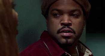 Movie still from “Barbershop” (2002), directed by Tim Story – A person wearing a hat; Close Up shot, Over the shoulder angle