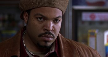 Movie still from “Barbershop” (2002), directed by Tim Story – A person wearing a hat; Close Up shot, Over the shoulder angle