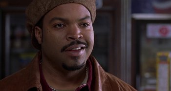 Movie still from “Barbershop” (2002), directed by Tim Story – A person wearing a hat; Close Up shot, Over the shoulder angle