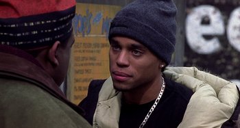 Movie still from “Barbershop” (2002), directed by Tim Story – A young man wearing a hat and a jacket; Close Up shot, Over the shoulder angle