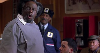 Movie still from “Barbershop” (2002), directed by Tim Story – A group of men standing next to each other in a room; Close Up shot, Low angle