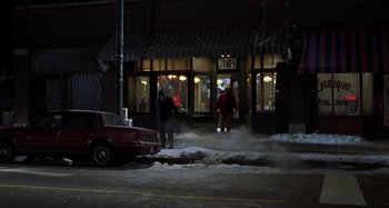 Movie still from “Barbershop” (2002), directed by Tim Story – Two people are walking in the snow near a building; Extreme Wide shot, High angle