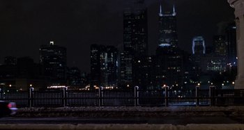 Movie still from “Barbershop” (2002), directed by Tim Story – A view of a city skyline at night; Extreme Wide shot, High angle