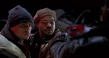 Movie still from “Barbershop” (2002), directed by Tim Story – Two men are looking at a camera in the dark; Close Up shot, Over the shoulder angle