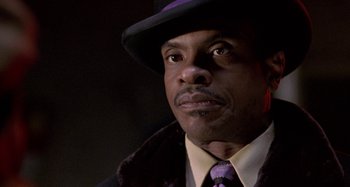 Movie still from “Barbershop” (2002), directed by Tim Story – A person wearing a purple hat; Close Up shot, Low angle