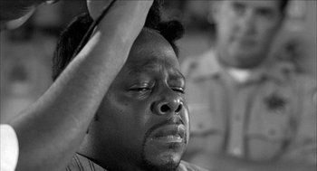 Movie still from “Barbershop 2: Back in Business” (2004), directed by Kevin Rodney Sullivan – A black and white photo of a man with his eyes closed; Close Up shot, High angle