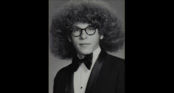 Movie still from “Barbershop 2: Back in Business” (2004), directed by Kevin Rodney Sullivan – A young man in a suit and bow tie with an afro wig; Close Up shot, Low angle