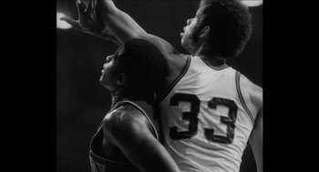 Movie still from “Barbershop 2: Back in Business” (2004), directed by Kevin Rodney Sullivan – Two basketball players in black and white playing a game; Close Up shot, Low angle
