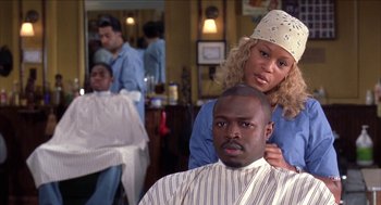 Movie still from “Barbershop 2: Back in Business” (2004), directed by Kevin Rodney Sullivan – A man getting his hair cut at a barber shop; Close Up shot, Over the shoulder angle