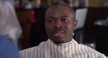Movie still from “Barbershop 2: Back in Business” (2004), directed by Kevin Rodney Sullivan – A person wearing a striped shirt; Close Up shot, Low angle