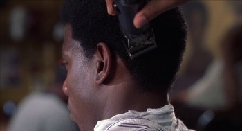 Movie still from “Barbershop 2: Back in Business” (2004), directed by Kevin Rodney Sullivan – A man getting his hair cut with a hair trimmer; Close Up shot, Over the shoulder angle