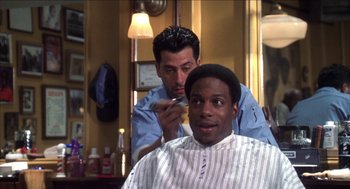 Movie still from “Barbershop 2: Back in Business” (2004), directed by Kevin Rodney Sullivan – A man getting his hair cut by a barber; Close Up shot, Over the shoulder angle