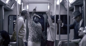 Movie still from “Barbershop 2: Back in Business” (2004), directed by Kevin Rodney Sullivan – A group of people riding on a train; Medium shot, Low angle