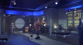 Movie still from “Barbershop 2: Back in Business” (2004), directed by Kevin Rodney Sullivan – A man standing in front of a basketball on a court; Wide shot, High angle