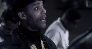 Movie still from “Barbershop 2: Back in Business” (2004), directed by Kevin Rodney Sullivan – A man in a black hat and a black jacket; Close Up shot, Low angle
