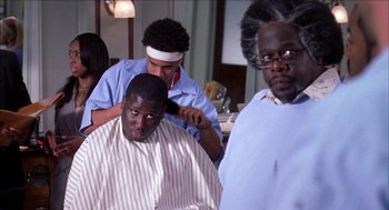 Movie still from “Barbershop 2: Back in Business” (2004), directed by Kevin Rodney Sullivan – A man getting his hair cut at a barber shop; Close Up shot, Over the shoulder angle