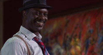 Movie still from “Barbershop 2: Back in Business” (2004), directed by Kevin Rodney Sullivan – A man wearing a hat and a tie; Close Up shot, Low angle