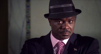 Movie still from “Barbershop 2: Back in Business” (2004), directed by Kevin Rodney Sullivan – A man wearing a suit and a hat; Close Up shot, High angle