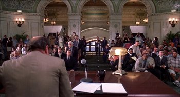 Movie still from “Barbershop 2: Back in Business” (2004), directed by Kevin Rodney Sullivan – A group of people sitting around a table; Wide shot, Over the shoulder angle