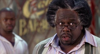 Movie still from “Barbershop 2: Back in Business” (2004), directed by Kevin Rodney Sullivan – A person wearing glasses and a wig; Close Up shot, Over the shoulder angle
