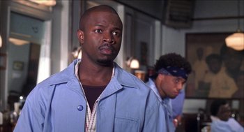 Movie still from “Barbershop 2: Back in Business” (2004), directed by Kevin Rodney Sullivan – A man in a blue shirt and a man in a blue jacket; Close Up shot, Low angle