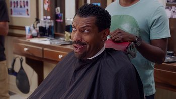 Movie still from “Barbershop: The Next Cut” (2016), directed by Malcolm D. Lee – A man getting his hair combed by a woman; Close Up shot, Over the shoulder angle