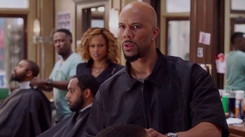 Movie still from “Barbershop: The Next Cut” (2016), directed by Malcolm D. Lee – A man with a beard is looking into the camera; Close Up shot, Over the shoulder angle