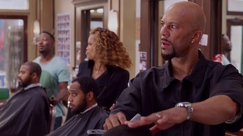 Movie still from “Barbershop: The Next Cut” (2016), directed by Malcolm D. Lee – A group of people sitting in a hair salon; Close Up shot, Over the shoulder angle