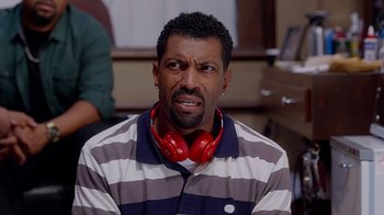 Movie still from “Barbershop: The Next Cut” (2016), directed by Malcolm D. Lee – A man with red headphones is standing in a room; Close Up shot, High angle