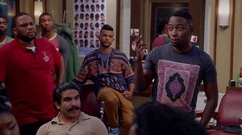 Movie still from “Barbershop: The Next Cut” (2016), directed by Malcolm D. Lee – A group of men sitting in front of a mirror; Medium shot, Over the shoulder angle