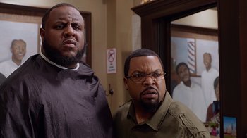 Movie still from “Barbershop: The Next Cut” (2016), directed by Malcolm D. Lee – A couple of men standing next to each other in a room; Close Up shot, Over the shoulder angle
