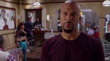 Movie still from “Barbershop: The Next Cut” (2016), directed by Malcolm D. Lee – A bald man with a beard in front of a mirror; Close Up shot, Over the shoulder angle