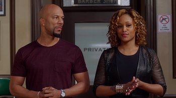 Movie still from “Barbershop: The Next Cut” (2016), directed by Malcolm D. Lee – A man and a woman standing next to each other in front of a barber shop; Medium shot, Over the shoulder angle