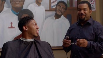 Movie still from “Barbershop: The Next Cut” (2016), directed by Malcolm D. Lee – Two men in front of a painting of a barber shop; Close Up shot, Over the shoulder angle