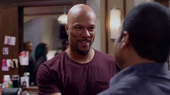 Movie still from “Barbershop: The Next Cut” (2016), directed by Malcolm D. Lee – A man with a beard is talking to another man; Close Up shot, Over the shoulder angle