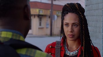 Movie still from “Barbershop: The Next Cut” (2016), directed by Malcolm D. Lee – A woman in a red jacket is talking to a man in a yellow jacket; Close Up shot, Over the shoulder angle