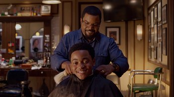 Movie still from “Barbershop: The Next Cut” (2016), directed by Malcolm D. Lee – A man getting his hair cut by another man; Close Up shot, Over the shoulder angle