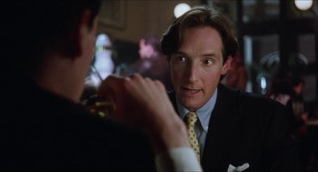 Movie still from “Barcelona” (1994), directed by Whit Stillman – A man in a suit and tie talking to another man in a suit and tie; Close Up shot, Over the shoulder angle