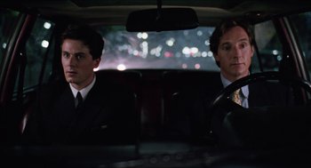 Movie still from “Barcelona” (1994), directed by Whit Stillman – Two men sitting in the back seat of a car at night; Medium shot, Over the shoulder angle