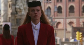 Movie still from “Barcelona” (1994), directed by Whit Stillman – A woman in a red jacket and a black hat; Close Up shot, Low angle