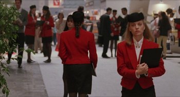 Movie still from “Barcelona” (1994), directed by Whit Stillman – A group of women in red jackets walking in a crowd; Medium shot, Over the shoulder angle