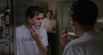 Movie still from “Barcelona” (1994), directed by Whit Stillman – A man shaving his face in front of a mirror; Close Up shot, Over the shoulder angle